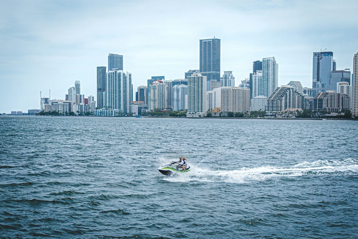Boat speeding across Biscayne Bay toward the Miami skyline