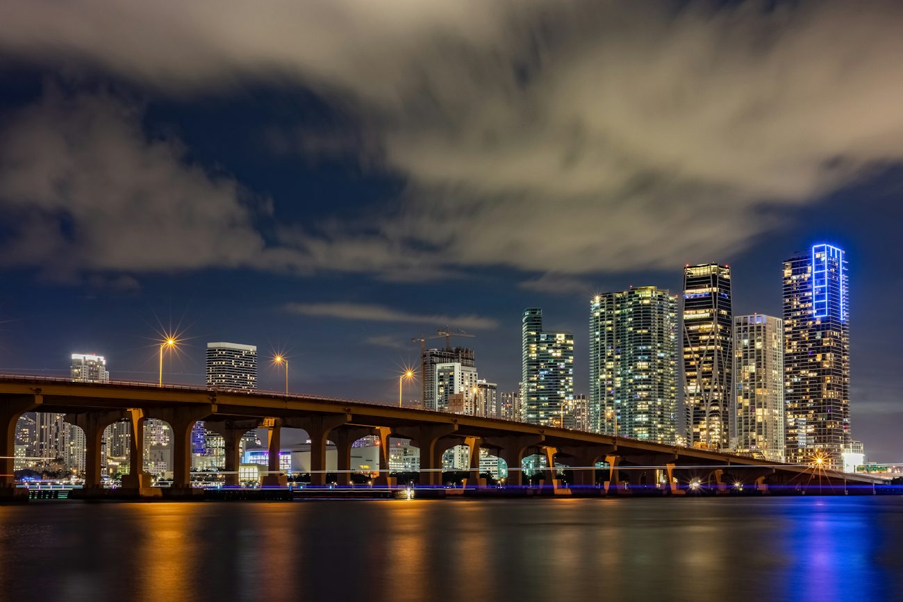 Causeway bridge and Miami skyline lit up at night