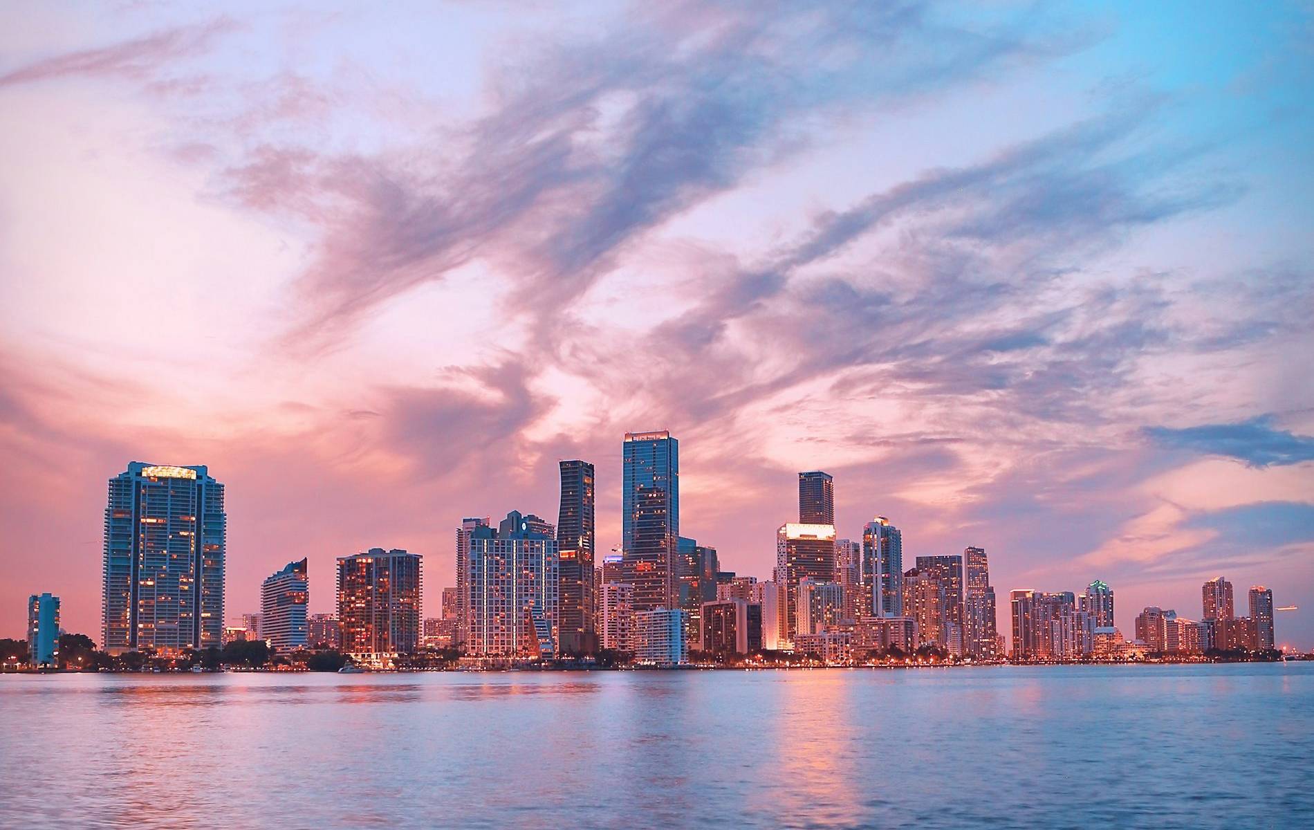 Downtown Miami skyline across Biscayne Bay at a pink sunset